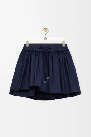 [One to One Official website] Loewe Mini Skirt in cotton Mini Skirt in lightweight cotton poplin featuring a layered construction and a lace-up detailing with polished glass-effect Anagram pebble.
